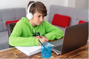 Kid with headset on laptop