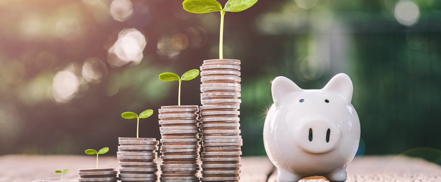 Stacked coins leading to a piggy bank