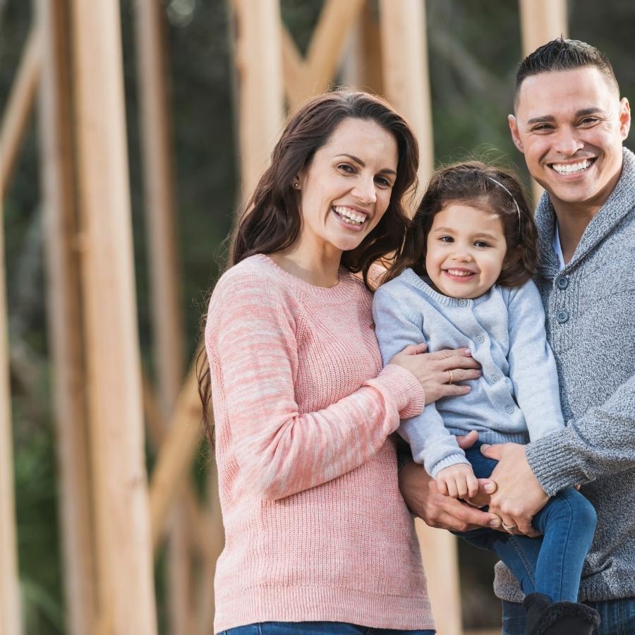 Family in front of new home